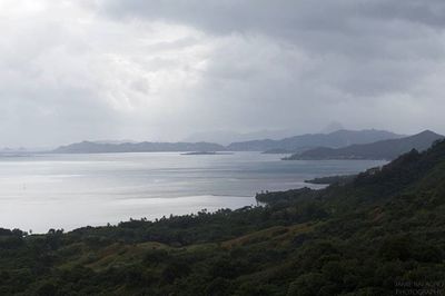 Scenic view of mountains against cloudy sky