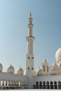 Low angle view of buildings against clear blue sky