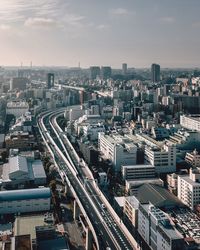 High angle view of street amidst buildings against sky