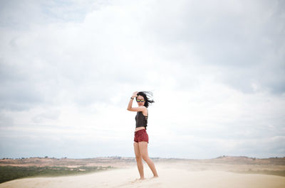 Side view of woman standing on beach