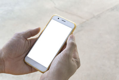 Close-up of hand holding mobile phone