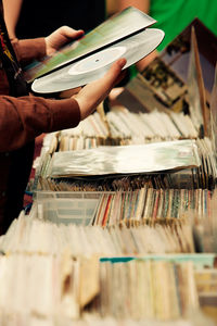 Cropped image of hand holding old vinyl record