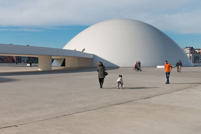 People walking in front of building