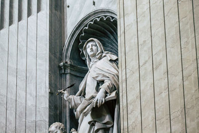 Low angle view of statue against building