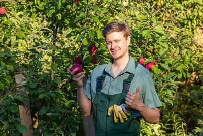 Portrait of young man holding apple