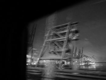 Blurred motion of illuminated city against sky at night
