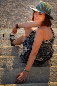 High angle portrait of woman sitting in hat