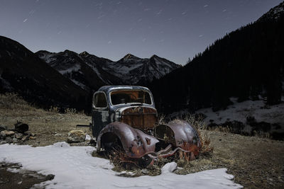 Snow on field against mountain range