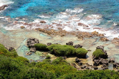 High angle view of rocks by sea