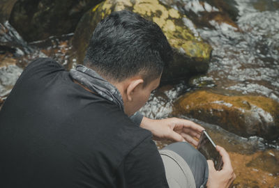 Rear view of man on rock