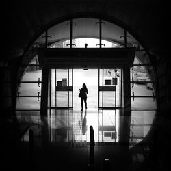 Full length of woman standing on railing