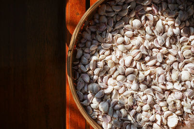 Fresh garlic cloves on bamboo basket tray, an essential cooking ingredient. pattern background.