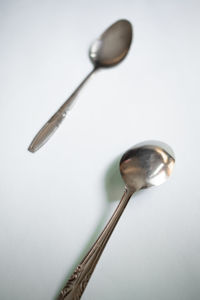 Close-up of electric lamp on table against white background