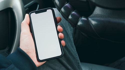Midsection of person using mobile phone