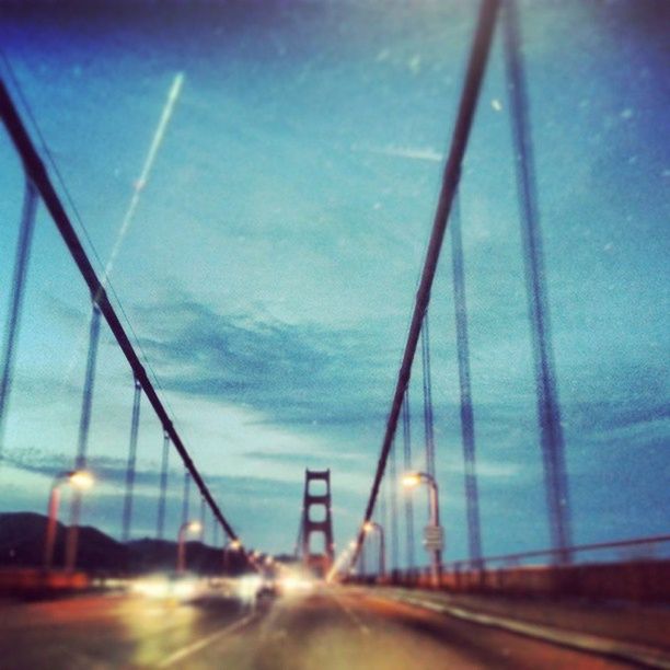 transportation, the way forward, road, connection, diminishing perspective, sky, bridge - man made structure, vanishing point, highway, motion, blurred motion, long exposure, engineering, illuminated, built structure, road marking, speed, blue, long, bridge