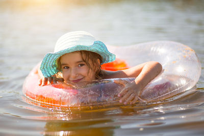 Portrait of smiling girl swimming in lake