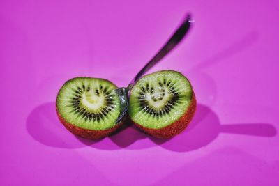 Close-up of fruits against pink background