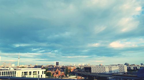 High angle view of buildings against cloudy sky