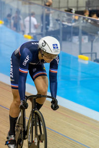 Man riding bicycle in swimming pool