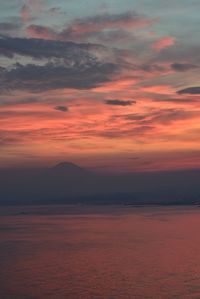 View of sea against cloudy sky during sunset