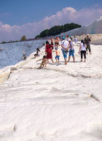 People on beach against sky