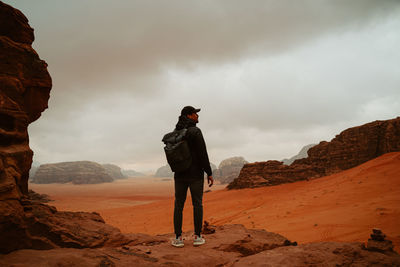 Rear view of man standing on mountain