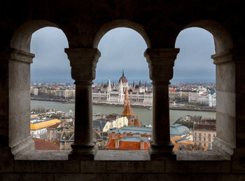 Buildings at waterfront against sky