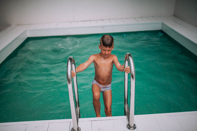 High angle view of shirtless man in swimming pool