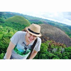 Young woman wearing hat against mountains