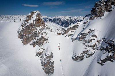 People skiing on snowcapped mountain