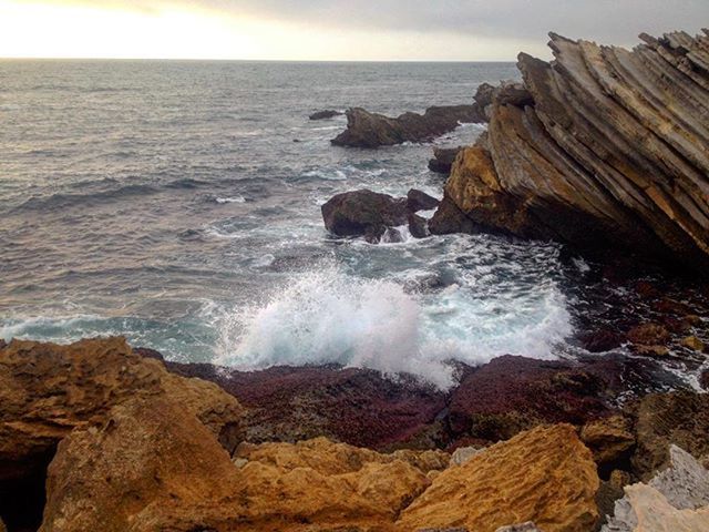 WAVES SPLASHING ON ROCKS AT BEACH