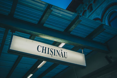 Low angle view of information sign against building