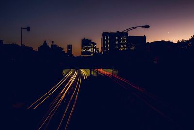 Low angle view of illuminated city against sky at night