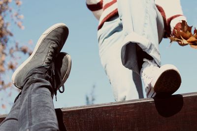 Low section of people on wooden wall during autumn