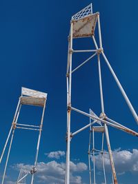 Low angle view of crane against blue sky