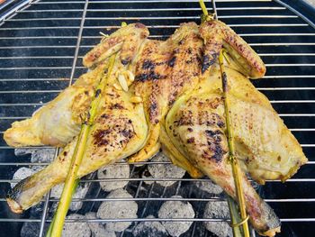 High angle view of meat on barbecue grill