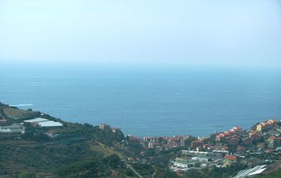 High angle view of townscape by sea against sky
