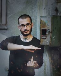 Portrait of young man standing by text