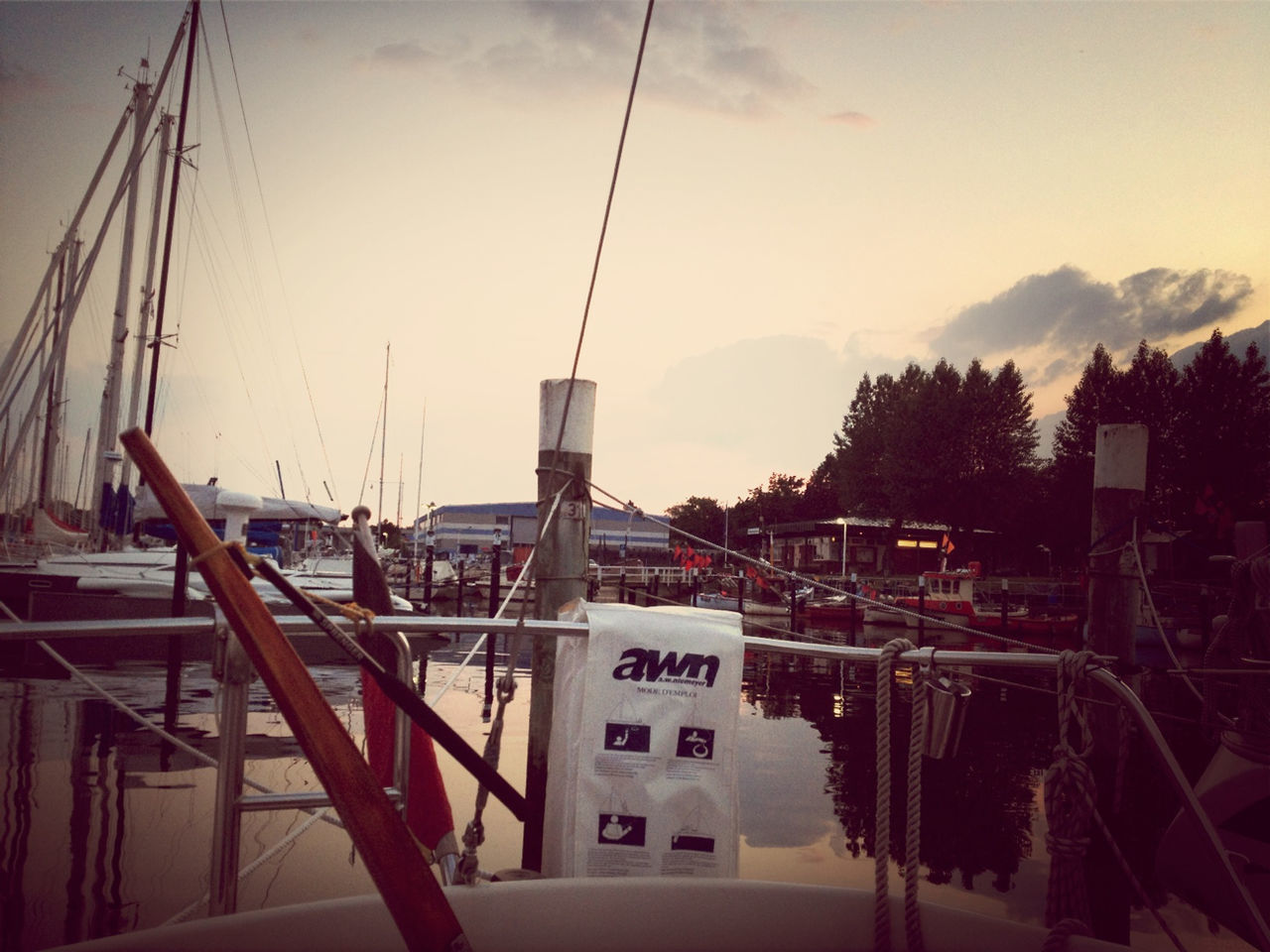 sky, transportation, nautical vessel, mode of transport, boat, moored, mountain, built structure, sea, water, architecture, cloud - sky, outdoors, tree, nature, day, mast, no people, harbor, pole