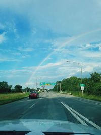 Cars on road against sky