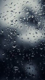 Full frame shot of raindrops on glass window