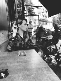 Full length of woman sitting on bench