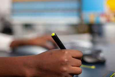 Close-up of hand holding pencils