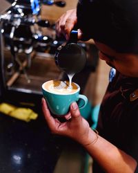 Close-up of woman holding coffee