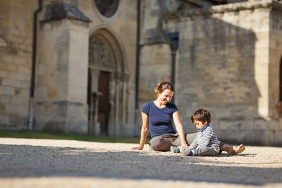 Mother and little eastern handsome baby boy playing outdoor in the park