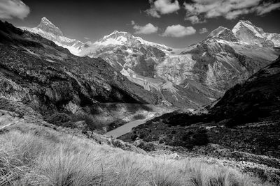 Scenic view of mountains against cloudy sky