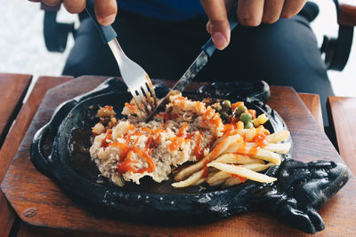 Midsection of person preparing food on table