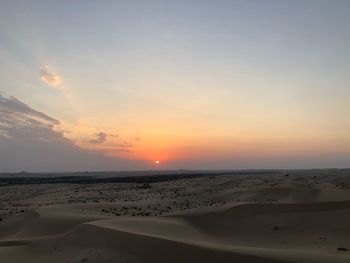 Scenic view of desert against sky during sunset