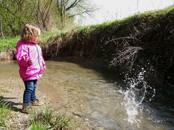 Rear view of girl standing in water