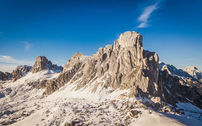 Scenic view of snowcapped mountains against blue sky